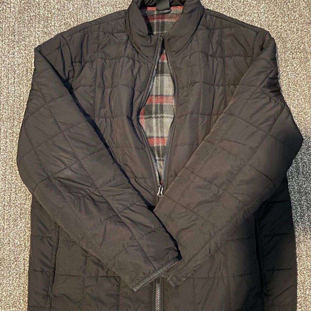 Black quilted puffer jacket with zipper closure, pockets, and fleece lining